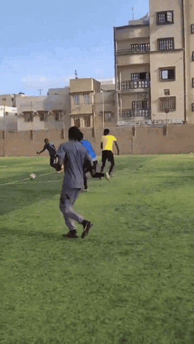 People Playing Soccer Near Building GIF