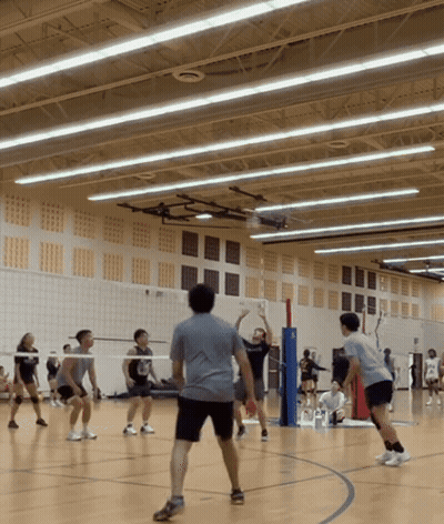 People Playing Volleyball In Gym With Shirt Saying Volleyball GIF