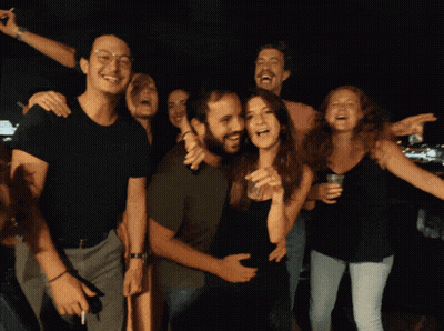 People Posing With Woman Holding Glass GIF
