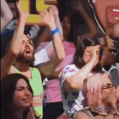 People Raising Arms And Man Holding Sign Saying I GIF