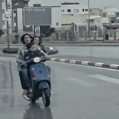 People Riding Scooter At La Guarimba Film Festival GIF