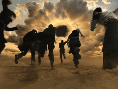 People Running In Desert With Cloudy Sky GIF