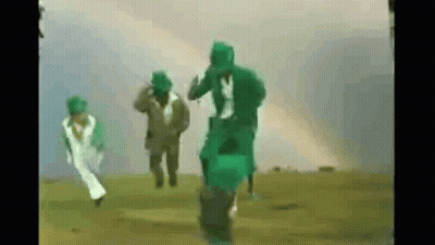 People Running In Field With Green Gas Masks GIF