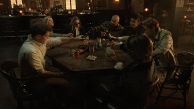 People Sitting Around Table In Dark Room GIF