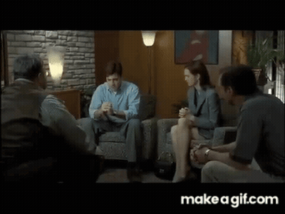 People Sitting Around Table In Living Room GIF