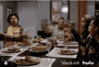 People Sitting Around Table With Food And Wine GIF