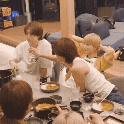 People Sitting At Table With Food Bowls GIF