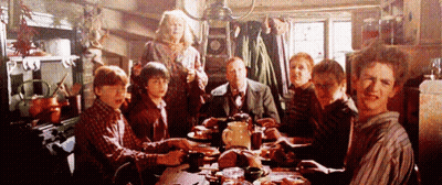 People Sitting At Table With Food Plates GIF