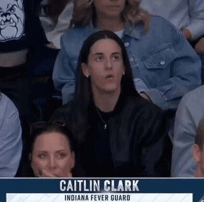 People Sitting In Stadium With Caitlin Clark On Screen GIF