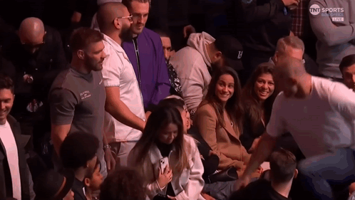 People Sitting In Stadium With TNT Sports Logo GIF
