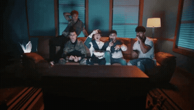 People Sitting On Couch Watching TV GIF