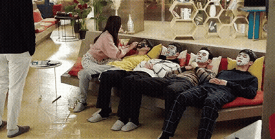 People Sitting On Couch With Face Masks GIF