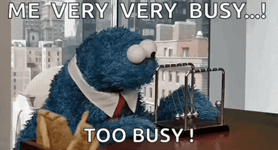 People Sitting On Grass In Front Of Large House GIF