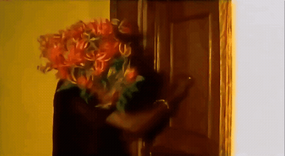 People Standing Around Man In Suit And Tie GIF