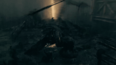 People Standing In Dark Room With Ceiling Light GIF