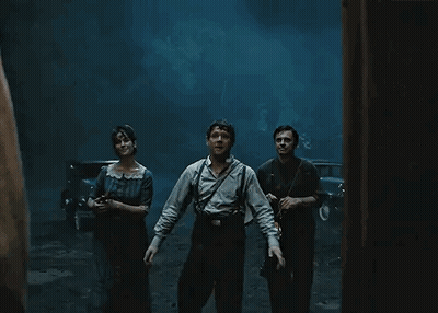 People Standing In Dark Room With Lantern GIF