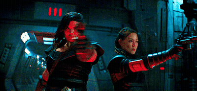 People Standing In Dark Room With Red Lights GIF
