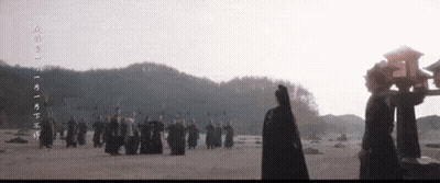 People Standing In Field With Chinese Writing GIF