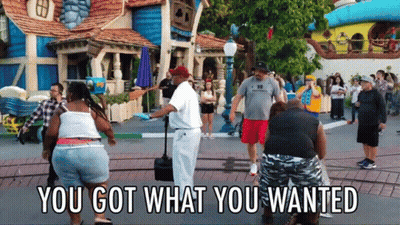 People Standing In Front Of Building Saying You Got What You Wanted GIF