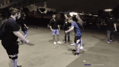 People Standing On Sidewalk Saying Is Now Following GIF