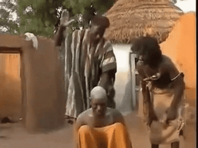 People Surrounding Man On Ground In Village GIF