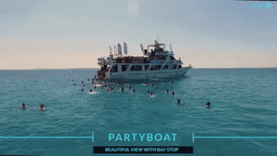 People Swimming Near Party Boat GIF