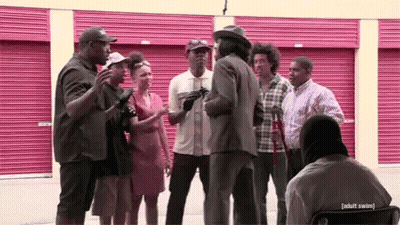People Talking In Front Of Pink Garage Door GIF