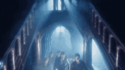 People Walking In Dark Tunnel With Blue Light GIF