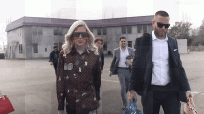 People Walking In Front Of Building GIF