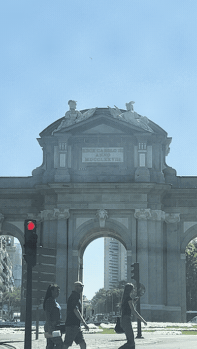 People Walking Under Stone Archway Puerta De Arco De Madrid GIF