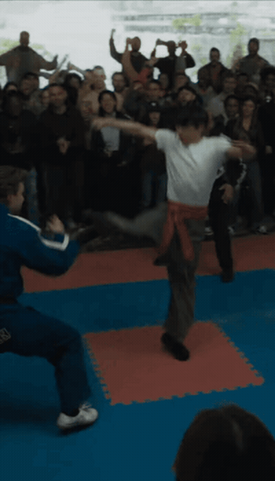 People Watching Man Kick Another In Air GIF