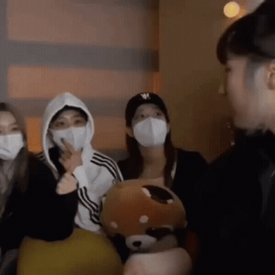People Wearing Face Masks Standing Together GIF