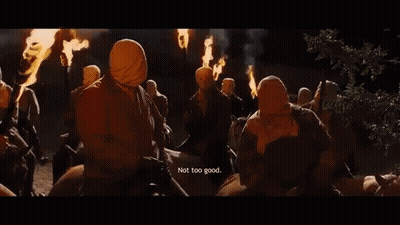 People Wearing Masks Holding Torches Saying Not Too Good GIF