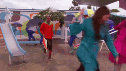 People With Colorful Raincoats Dancing In The Rain GIF