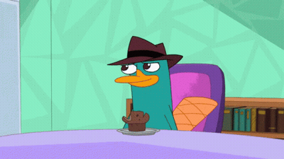 Perry The Platypus Sitting At Table With Cupcake GIF