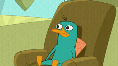 Perry The Platypus Sitting In Chair With Pillow GIF