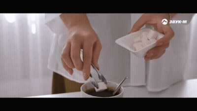 Person Adding Sugar To Coffee With Tongs GIF
