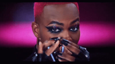 Person Applying Makeup On Pink Background GIF