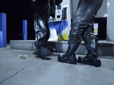 Person At Gas Pump With Gas Sign GIF
