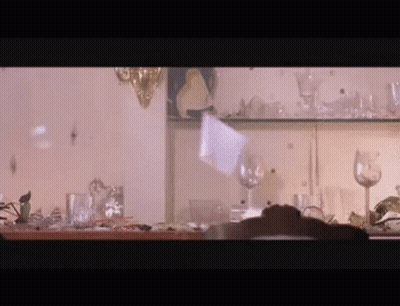 Person At Shelf Full Of Glasses And Plates GIF