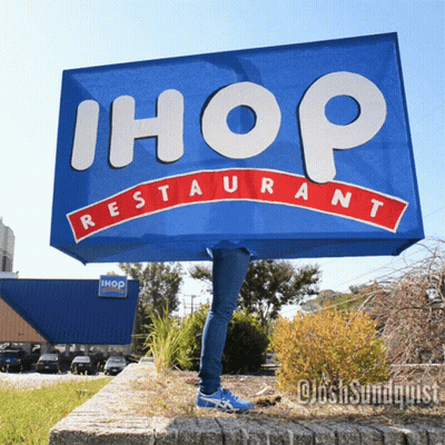 Person Behind Blue Ihop Restaurant Sign GIF