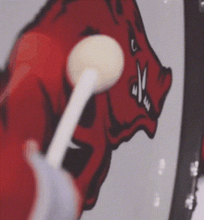 Person Brushing Teeth In Front Of Drawing Of A Boar GIF