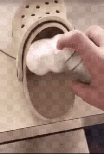 Person Cleaning Crocs With Foam GIF