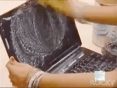 Person Cleaning Laptop With Rocky On Wrist GIF