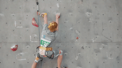 Person Climbing Wall With Number 128 Shirt GIF