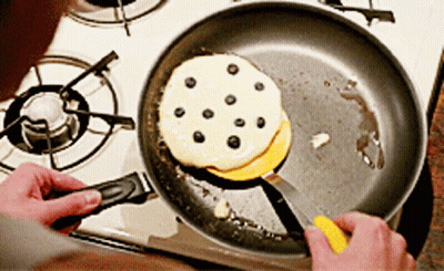 Person Cooking Pancakes With Blueberries GIF
