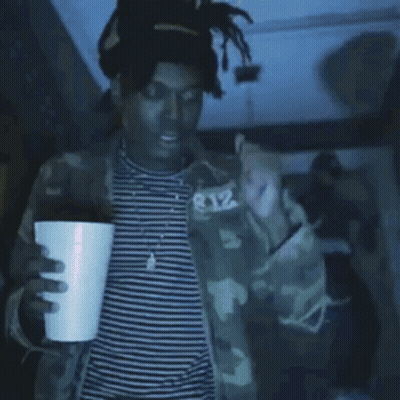 Person Covering Face In Purple Light GIF