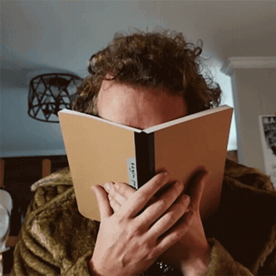 Person Covering Face With Book Saying A GIF