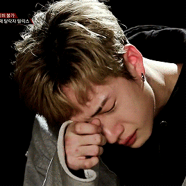 Person Covering Face With Hand And Chinese Writing GIF