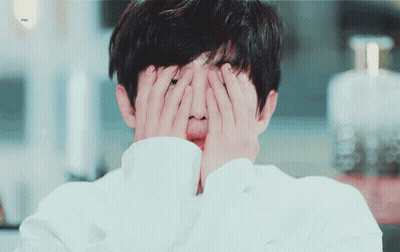 Person Covering Face With Hands Bottle Of Perfume GIF